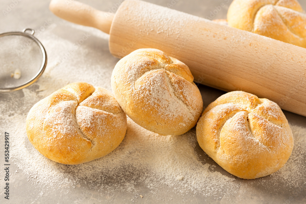 Poster set of fresh small bun bread on the light table with rolling pin. home baking concept