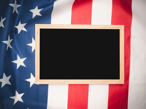 Top view of a mini chalkboard over the American flag background