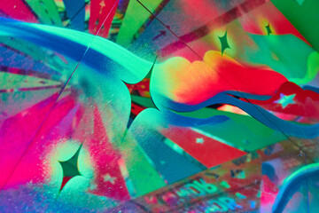 Stars on colorful glowing wall of artwork with mirrors