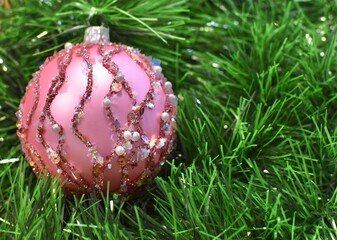 glass pink christmas ball with decoration on glass