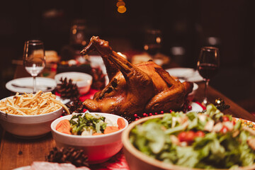 Baked chicken or turkey on served for Christmas table for Christmas Dinner and New Year with Christmas decorations.