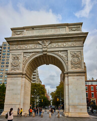 Panoramic view of Washington Square Park huge limestone arch with pedestrians