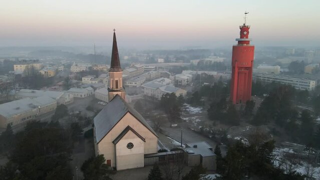 Water tower and church, foggy, spring sunrise in Hanko, Finland - Aerial view