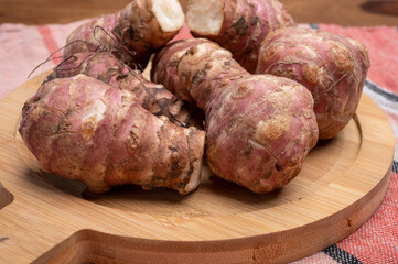 Group of fresh uncooked topinambur or Jerusalem artichoke roots