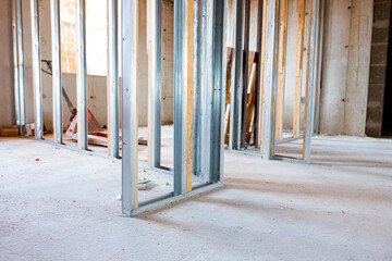 Frame for plasterboard wall, mounted vertical metal and wooden profiles, work in progress of unfinished edifice