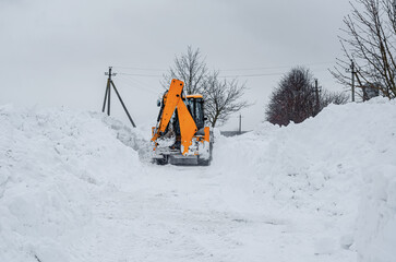 Yellow tractor removes snow outside