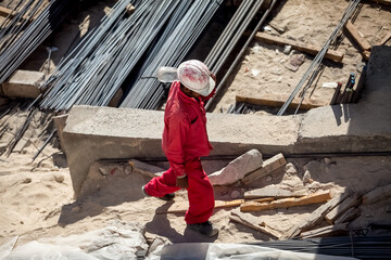 Worker on skyscraper construction. Modern arab city architecture