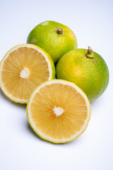 Obraz na płótnie Canvas Fresh ripe bergamot orange fruits, fragrant citrus used in earl grey tea, medicine and spa treatments on white background isolated