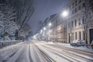 A snow-covered park in Krakow captured at night. Thanks to the large amount of snow, a fairy-tale...