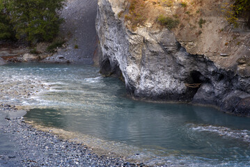 Close-up of Rhine River at Anterior Rhine Valley at Versam, Canton Graubünden, on a blue cloudy...