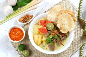 Soto Betawi. Traditional beef and offal soup from Betawi, Jakarta. The soup has been preplated in a bowl; ready to be served.