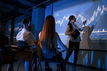 Exchange company. Female leader talking to employees, showing the plan on the projector in office...