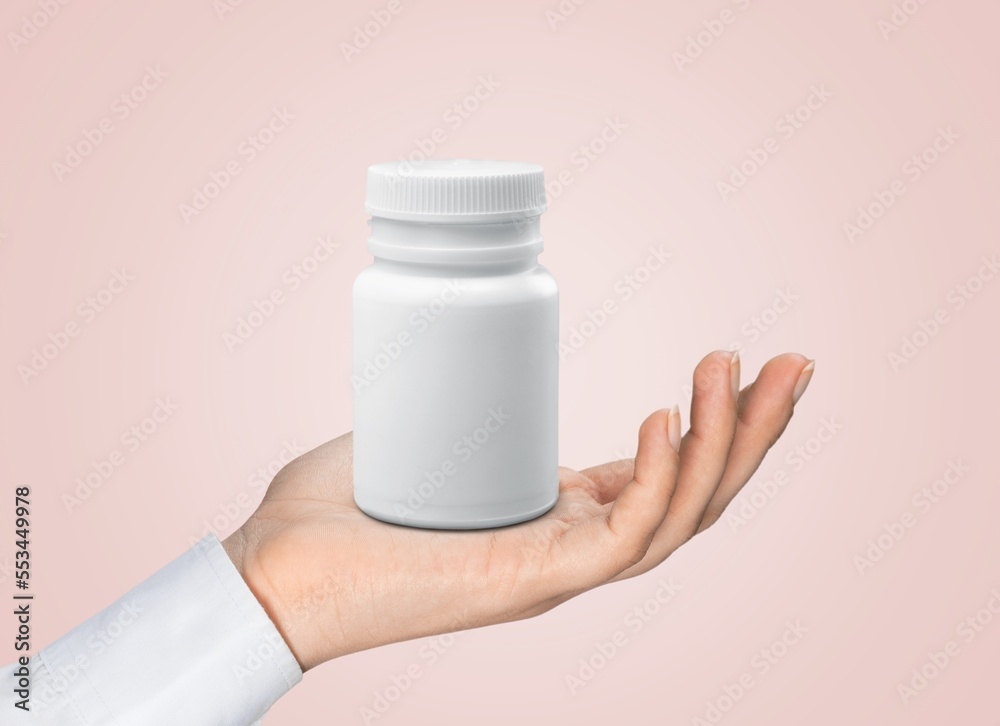 Canvas Prints Person's hand with blank medical plastic bottle for pill.