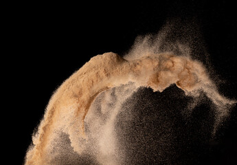 Small size fine Sand flying explosion, Golden grain wave explode. Abstract cloud fly. Yellow colored sand splash silica in Air. Black background Isolated high speed shutter, throwing freeze shot © Jade