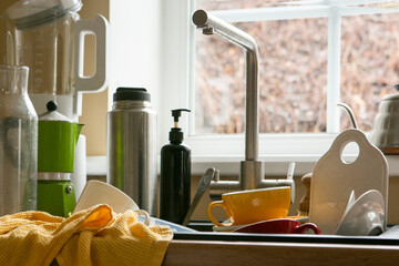 Fototapeta na wymiar mess in the kitchen, dirty dishes in the sink