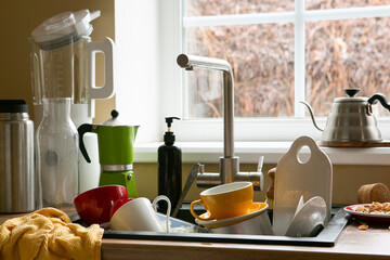 mess in the kitchen, dirty dishes in the sink