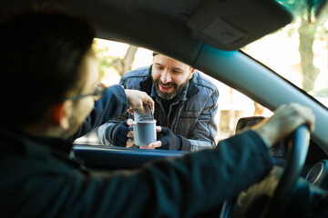 Homeless man asking for money to drivers