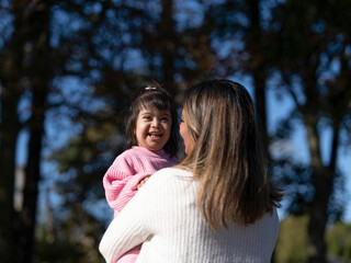 Obraz premium Mother hugging daughter with Down syndrome
