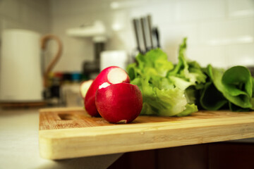 Radish and lettuce lying on a chopping board
