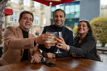 Portrait of business people raising toast in bar