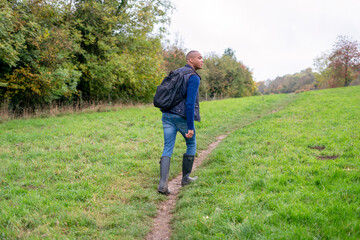 Fototapeta na wymiar Man walking on a path in meadow