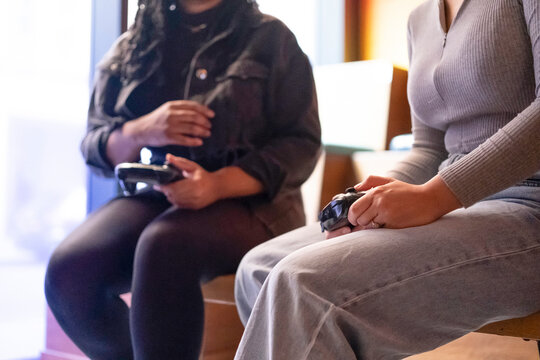 Female friends playing in video games at pub