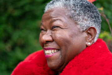 Portrait of senior woman wearing red fur coat