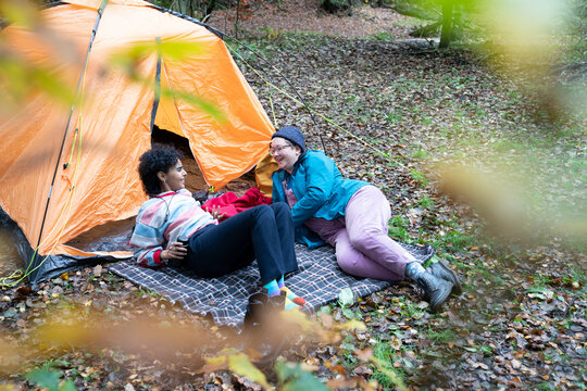 Two Women Camping In Forest