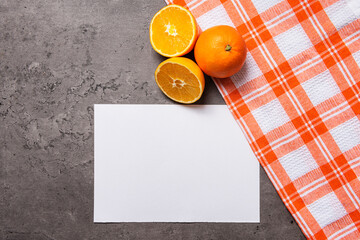 oranges with white checkered cloth sheet on dark marble background