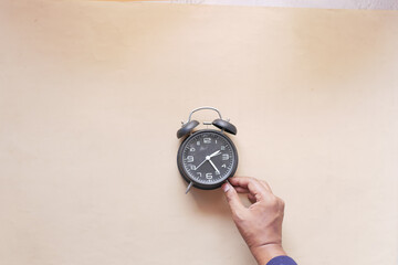 old alarm clock on color background.
