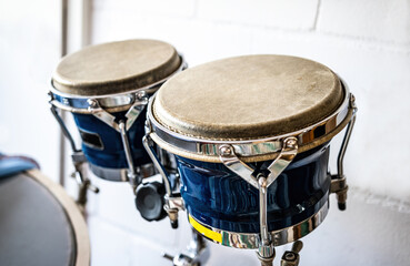 Fototapeta na wymiar Blue bongos drums in recording studio for hard beat perfomance. Professional musical instrument for rock concerts