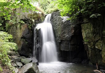 Fototapeta na wymiar View of a small cascade in summer, Derbyshire England 