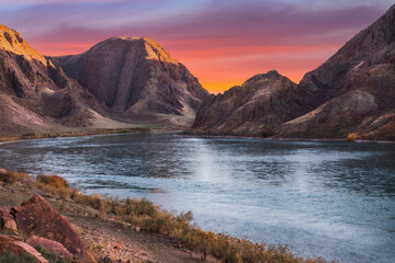 Ili river view in rocky gorge on sunrise sky background, Almaty region, Central asian nature scenery landscape.