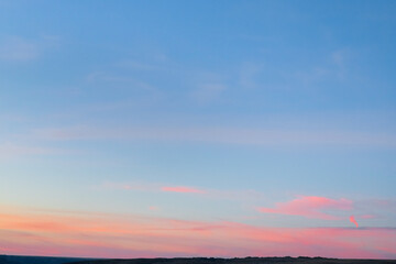 Fototapeta na wymiar Minimal artistic colorful sunrise sky background with orange and pink colors on horizon line.