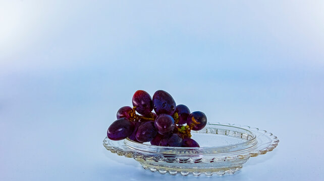 Blue grapes for dessert with a cup of coffee