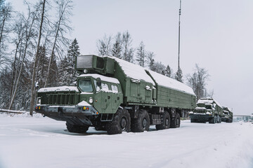 Heavy military equipment of Russian armed forces against the background of a winter forest