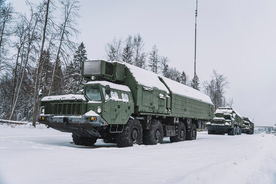 Heavy military equipment of Russian armed forces against the background of a winter forest