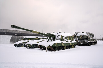 artillery on tracks under snow at a military base