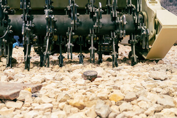 anti-personnel mine on the rocks. Mine clearance using armored mine clearance vehicle.