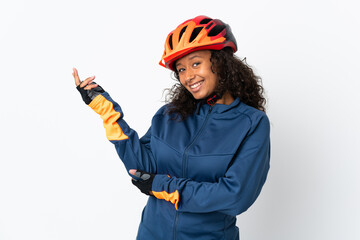 Teenager cyclist woman isolated on white background extending hands to the side for inviting to come - obrazy, fototapety, plakaty