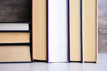 Collection of different books on white shelf, closeup