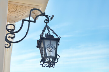 Fototapeta na wymiar Beautiful vintage street lamp hanging on wall of building