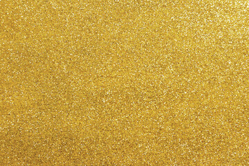 Beautiful golden shiny glitter as background, top view