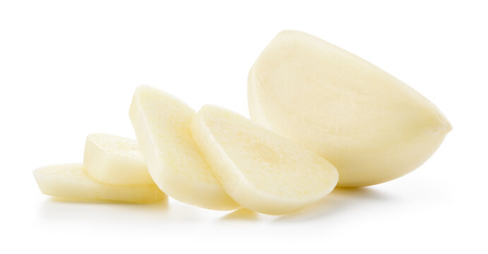 Garlic clove isolated. Peeled whole and chopped garlic cloves on white background. White garlic cloves with slices. Full depth of field. With clipping path.