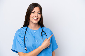 Young Brazilian nurse woman isolated on white background pointing to the side to present a product