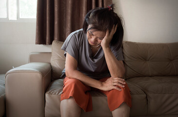 Fototapeta premium old asian woman feel headache and suffering from mental health