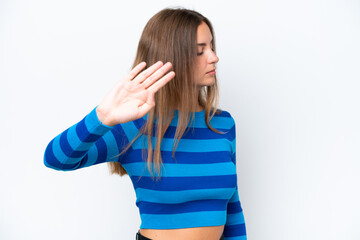 Young caucasian woman isolated on white background making stop gesture and disappointed