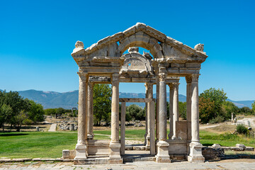 Facade view of Tetrapylon, monumental gate of Aphrodisias in Karacasu, Aydin, Turkey. The monumental columnar entrance to the sanctuary of Aphrodite. Copy space for text.