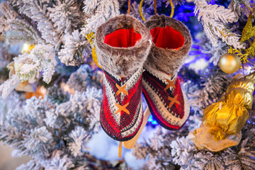 Shoes for getting Christmas presents adorned on the Christmas tree.
