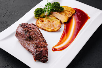 Appetizing fried pork with potatoes on plate